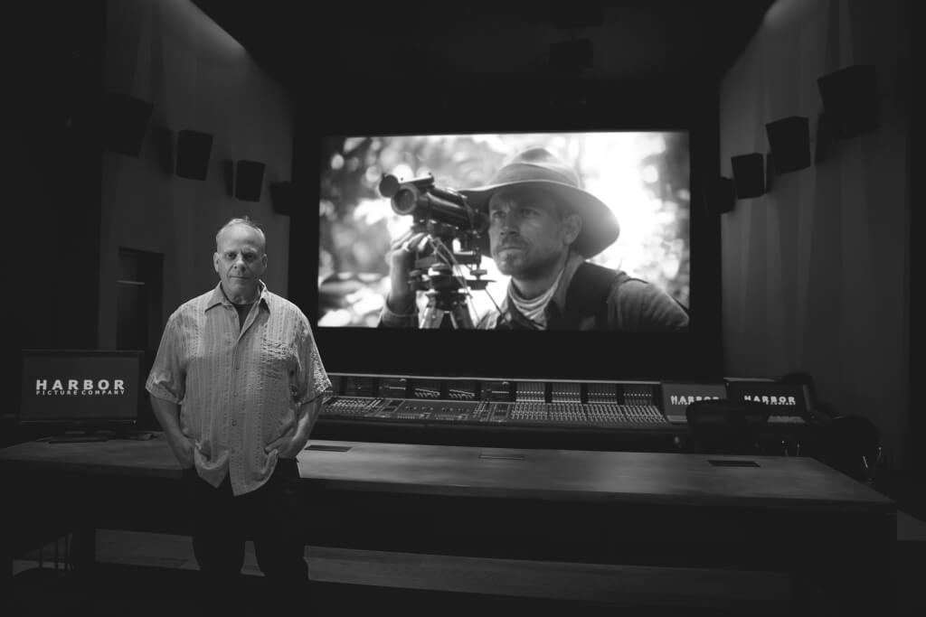 Bob Hein in the mix room at Harbor Post with a still from the film The Lost City of Z.